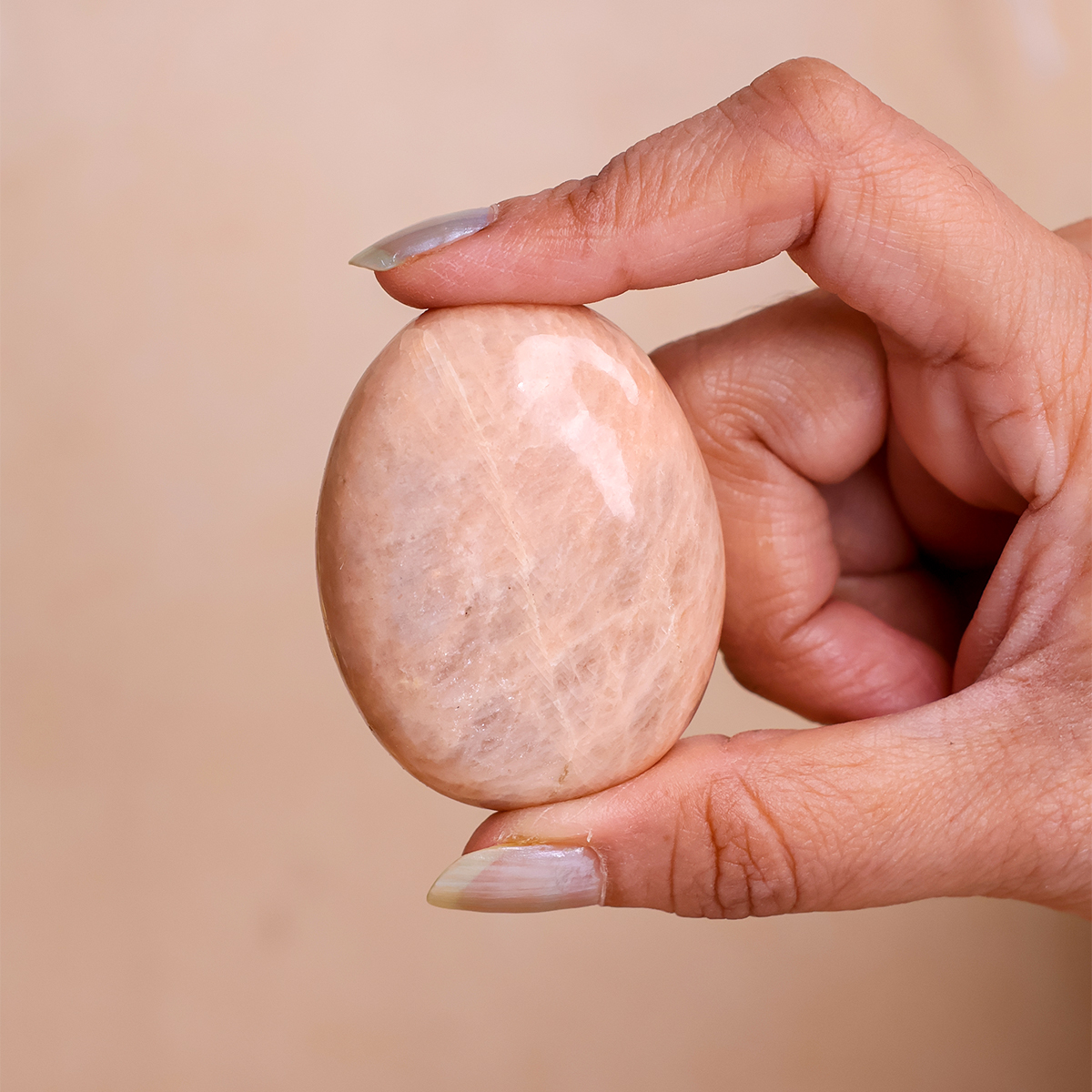 Peach Moonstone Palm Stone (3) peach moonstone palm stone 50 100 gms